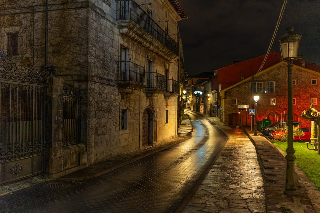 Empty cobblestone street in an old European city at night