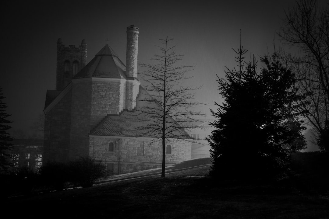 Gothic stone tower shrouded in fog at night